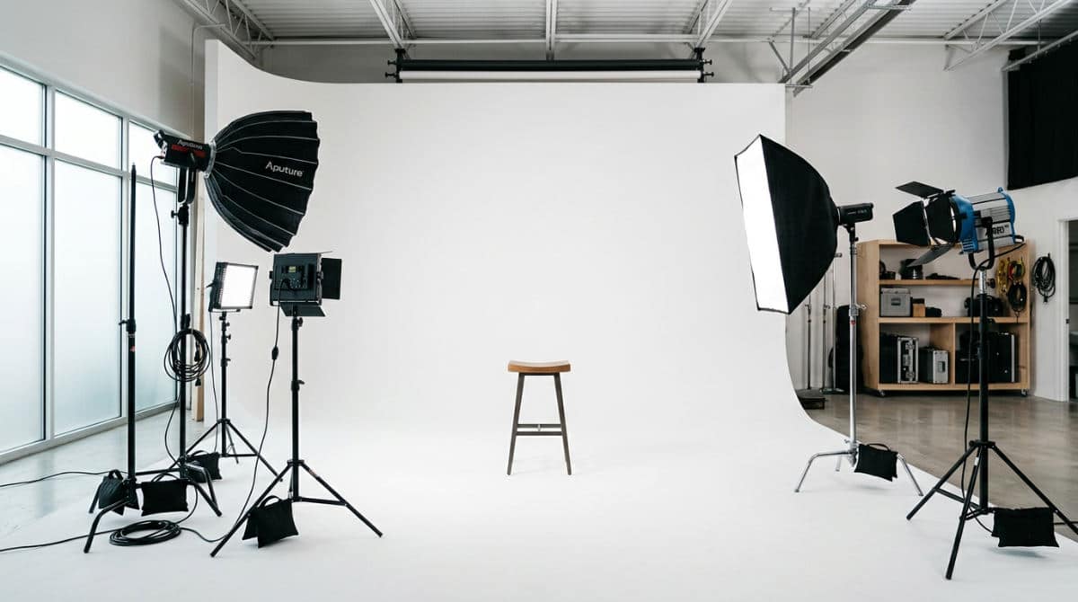 A professional photography studio in San Diego featuring a white cyclorama wall and premium lighting equipment for headshots.