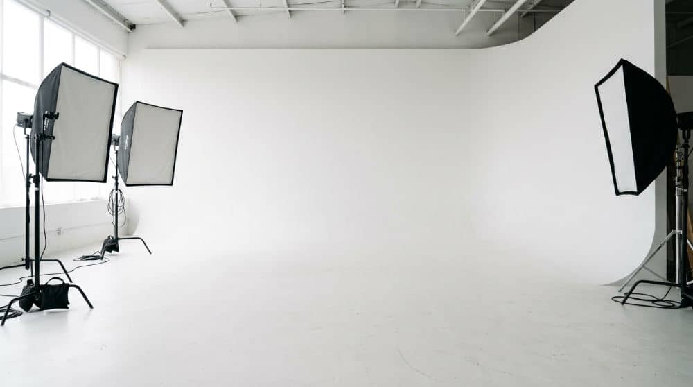 A clean white cyclorama wall in a professional studio showing the infinity background effect for holiday photography.