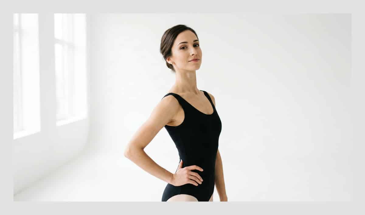A professional dancer posing for a headshot in a clean San Diego studio with professional lighting.