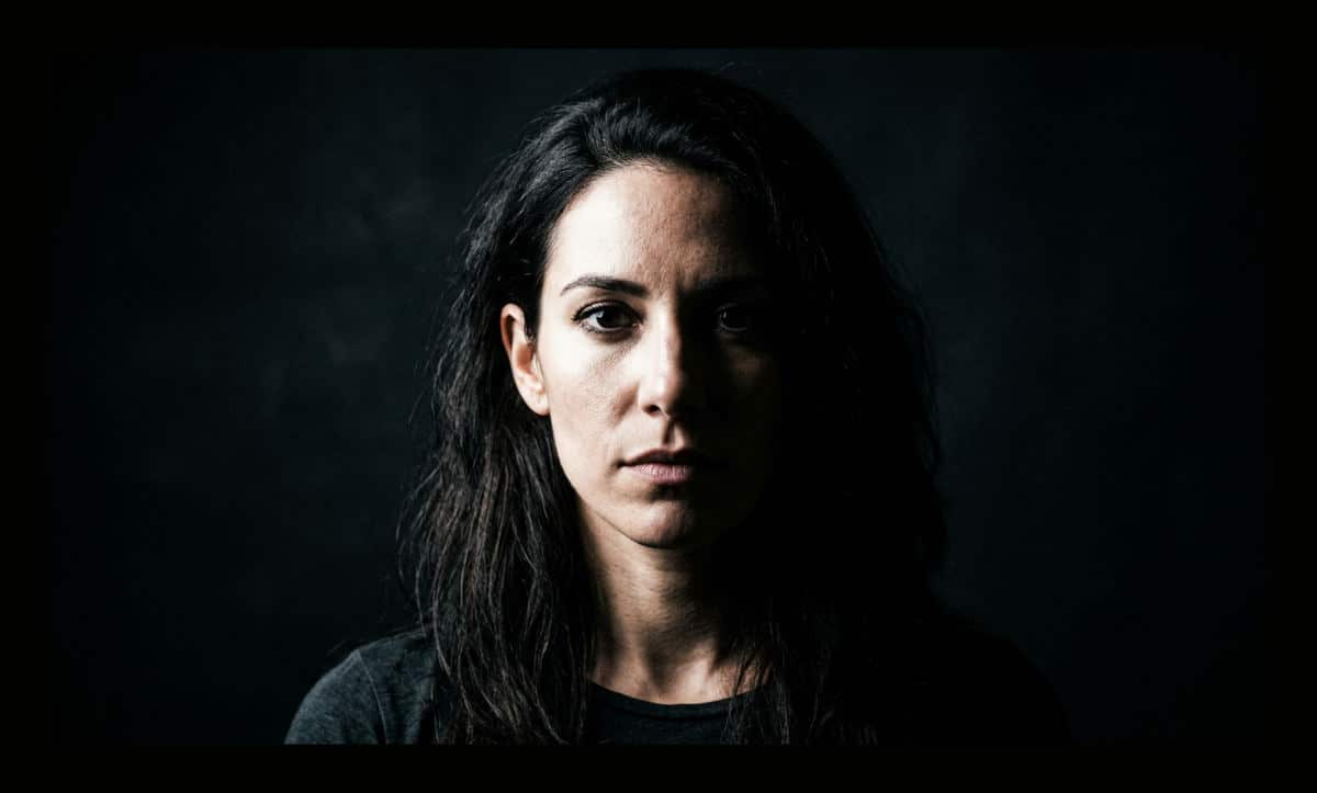 Dramatic high contrast photo showing light and shadow on a portrait