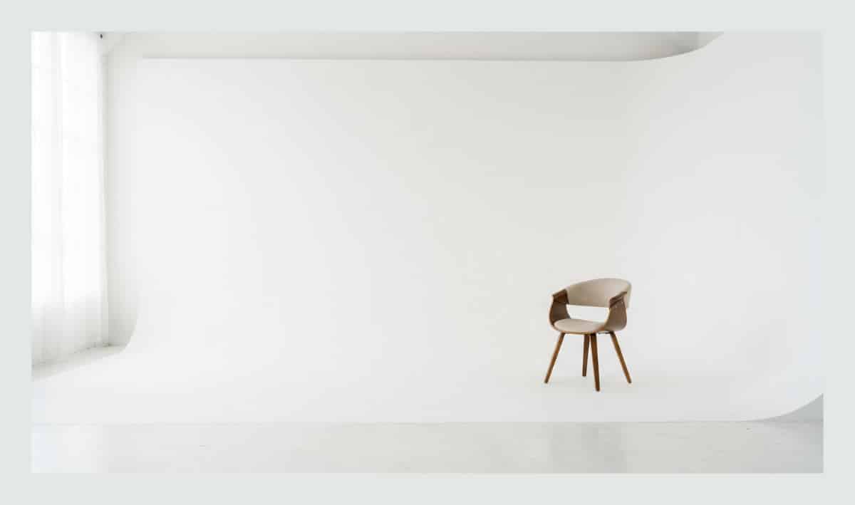 A professional San Diego studio setup with a white cyclorama wall demonstrating the effective use of negative space in photography.