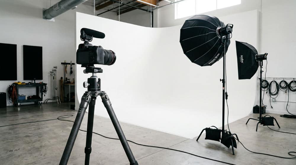 Camera on a tripod positioned for a long exposure shot in a professional photography studio.