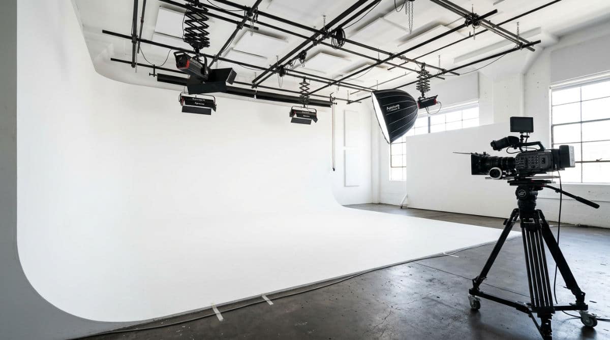 A professional San Diego photography studio featuring a clean white cyclorama wall and high-end lighting equipment for rent.