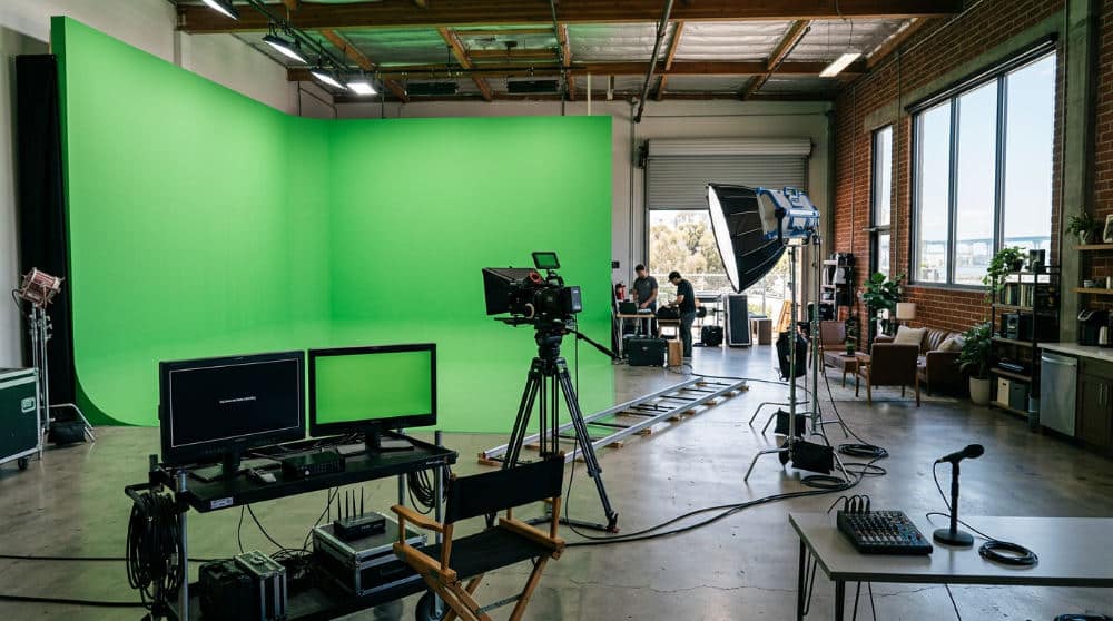 A video production space in San Diego featuring a large green screen backdrop for digital compositing.