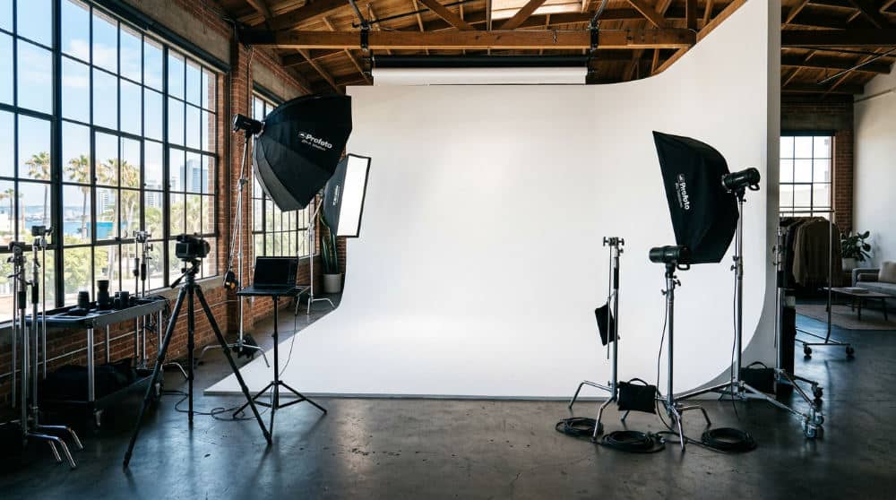 A large San Diego photography studio equipped with a white cyclorama wall and softbox lights for corporate portraits.