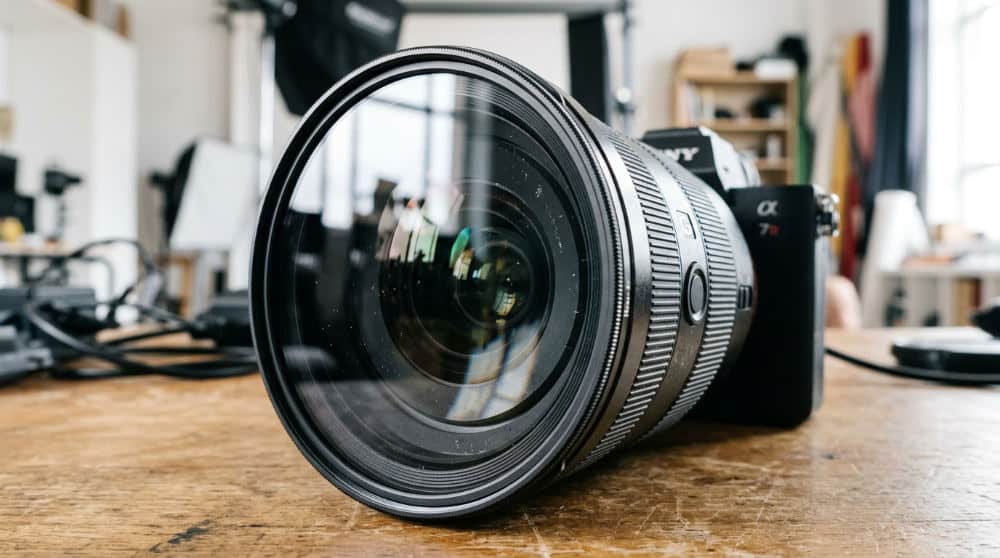 A camera lens with a circular polarizer filter attached to prevent glare in professional photography.